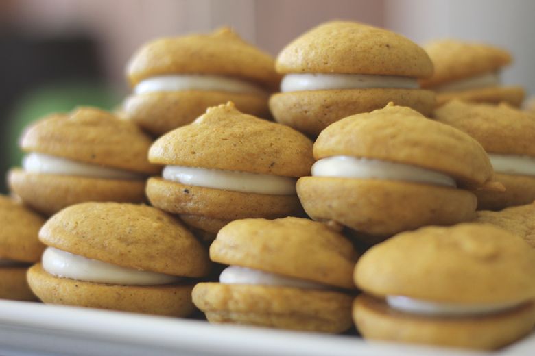 Soft Pumpkin Cream Cookies stacked on a plate.