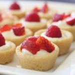 Sugar cookie tarts filled with sweetened cream cheese and topped with berries.