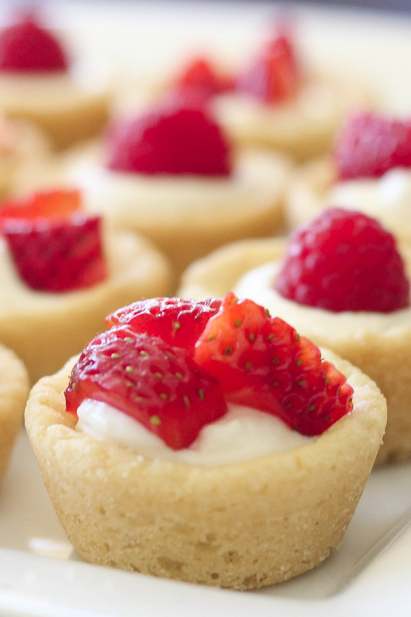 Sugar cookie tarts filled with sweetened cream cheese and topped with berries.