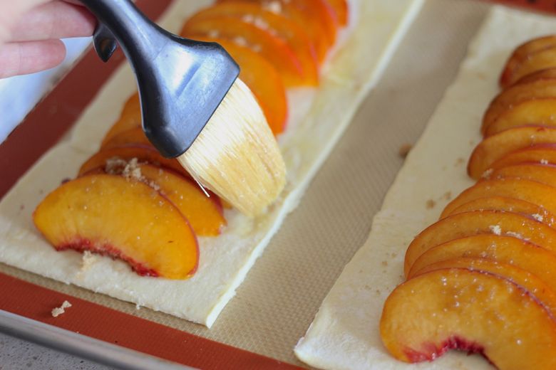 Egg wash brushed on edges of assembled Peach Tart before baking.  