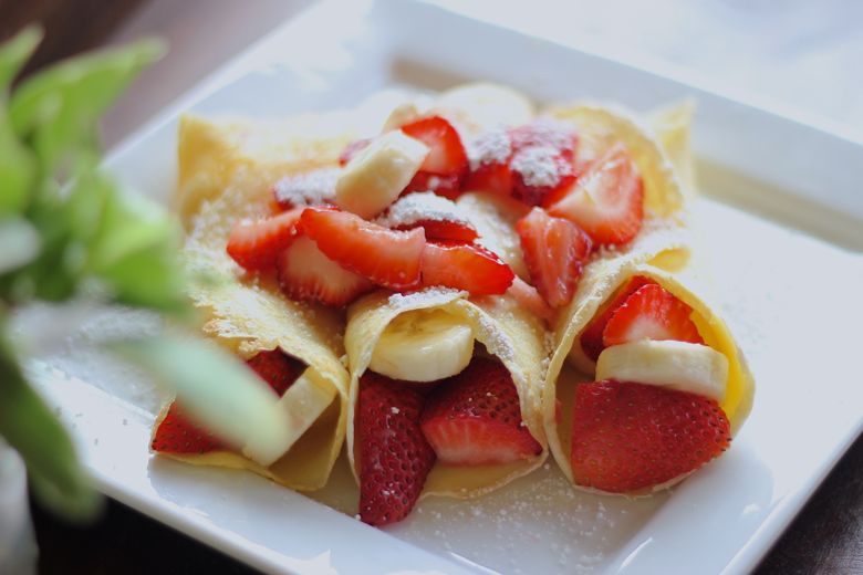 Strawberry Banana Crepes on a plate.  