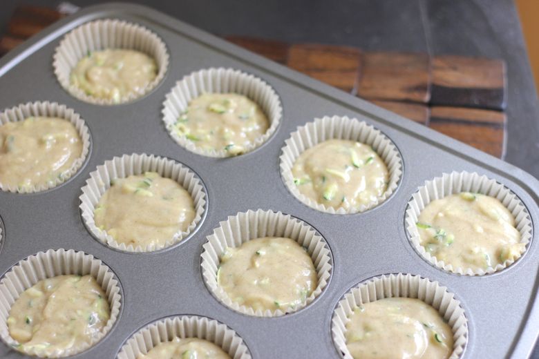 Zucchini Almond Cupcake batter in lined muffin tin. 