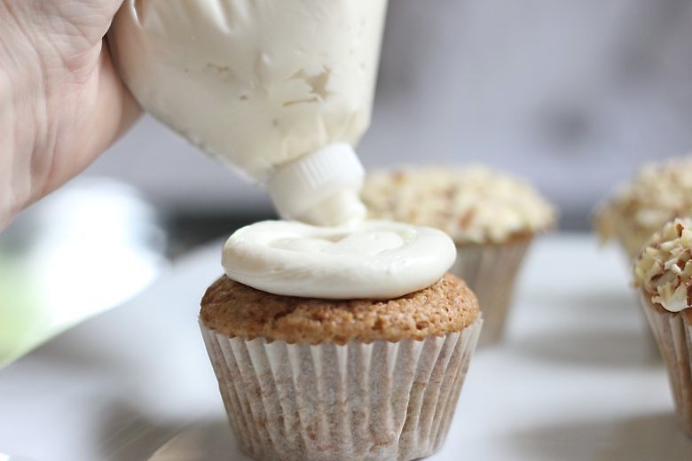 Zucchini Almond Cupcake being frosted. 