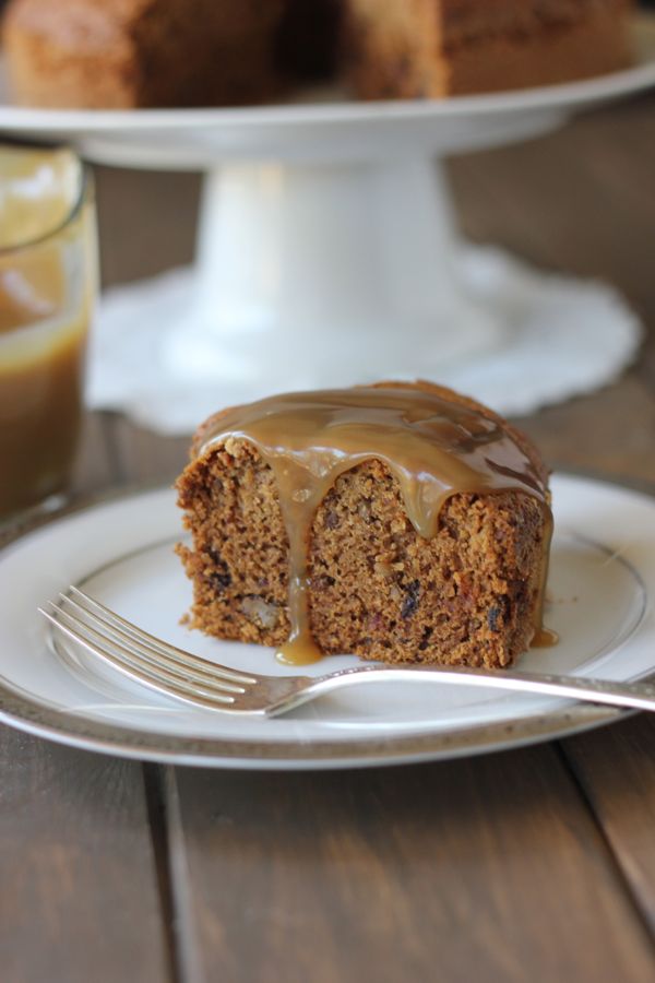 A slice of Applesauce Cake With Butterscotch Sauce on a plate with a fork.