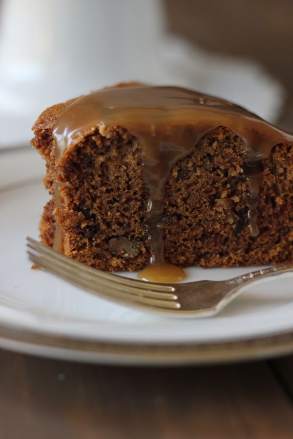 A slice of Applesauce Cake With Butterscotch Sauce on a plate with a fork.