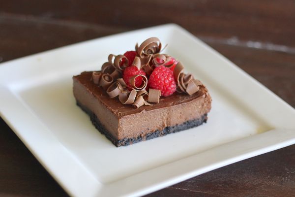 Chocolate Cheesecake with Raspberries on a plate.  