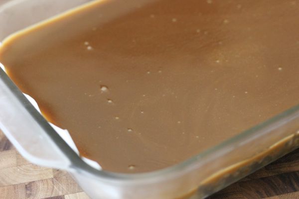 Salted Caramel Oat Bars caramel layer in a glass baking dish.  