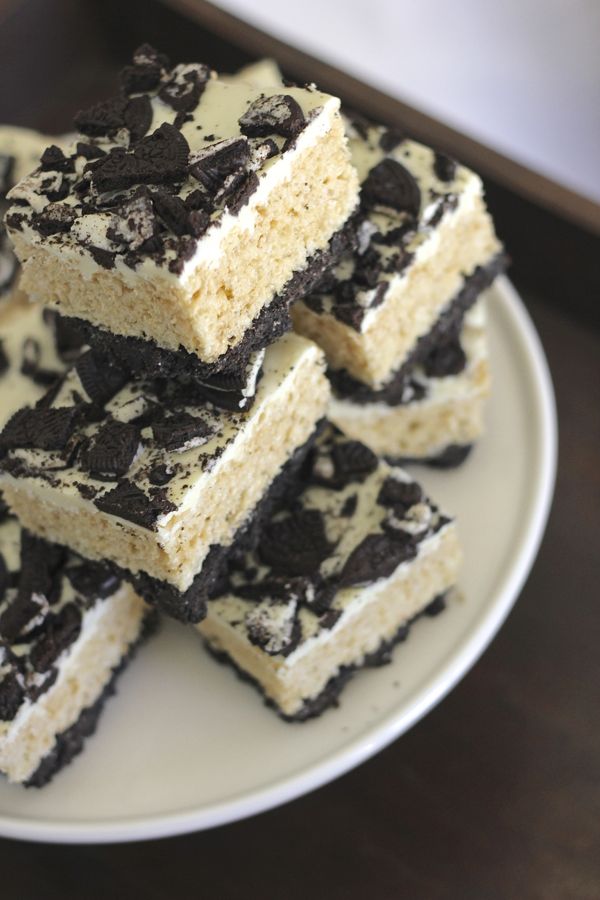 Cookies and Cream Rice Krispie Treats cut in squares and stacked on a plate.  