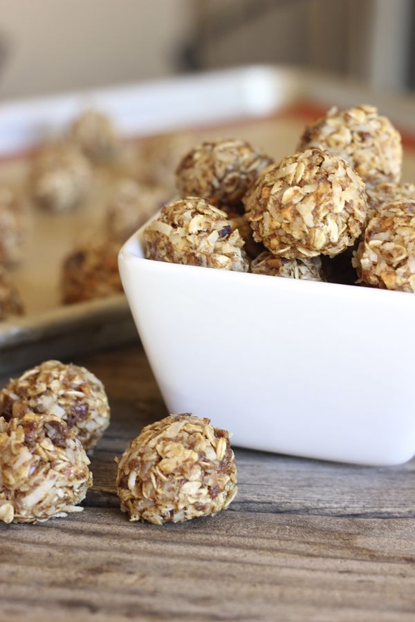 Honey Oat Energy Bites piled in a bowl with a few outside of the bowl. 