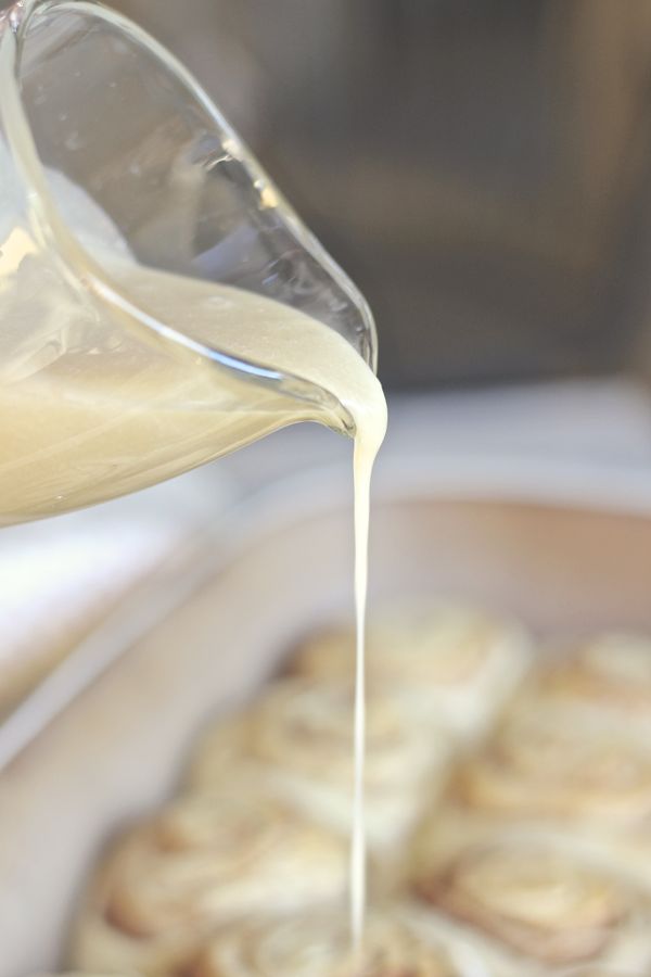 Maple Glaze being poured onto the Cinnamon Rolls.  