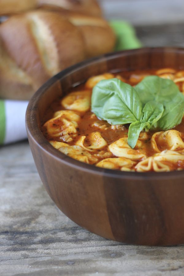 Easy Tomato Basil Soup With Chicken Sausage and Cheese Tortellini in a bowl with garnish on top.  