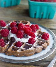 Not too sweet chocolate waffles with fresh raspberries and whipped cream!