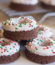 Iced Chocolate Donut Cookies - tiny bites of chewy chocolate cookie with powdered sugar icing and red and green nonpareils