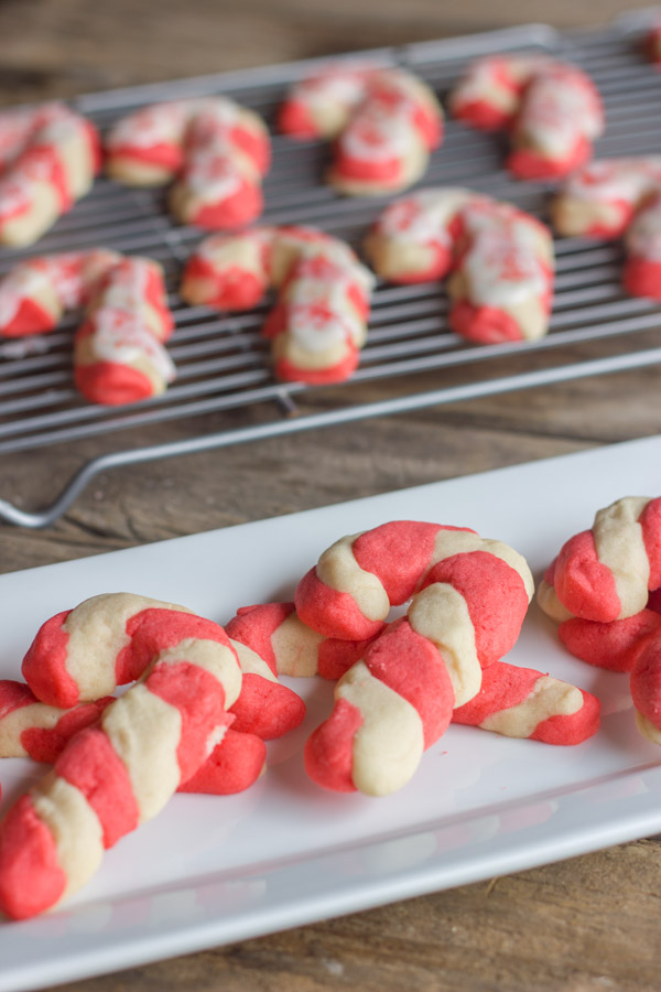 Candy Cane Sugar Cookies stacked on a serving plate.  
