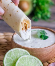 Sweet and spicy shredded chicken wrapped up in a crispy, crunchy baked tortilla with some Cilantro Lime Cream for dipping