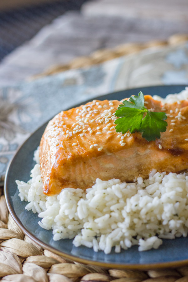Teriyaki Glazed Salmon served on top of a bed of white rice.