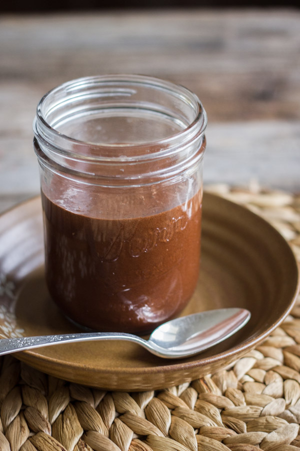 Two Ingredient All Natural Chocolate Syrup in a glass jar.
