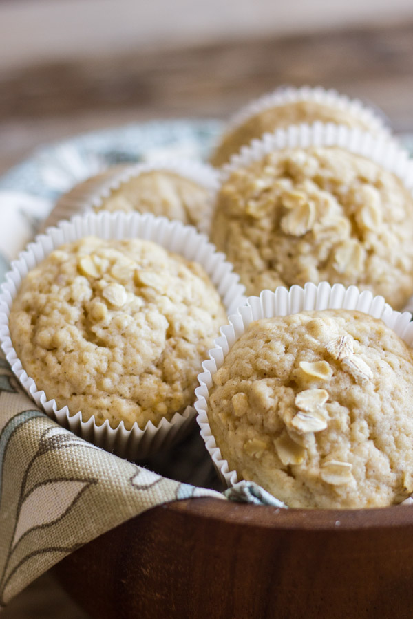 Healthy Applesauce Oat Muffins in a clothed lined bowl.   