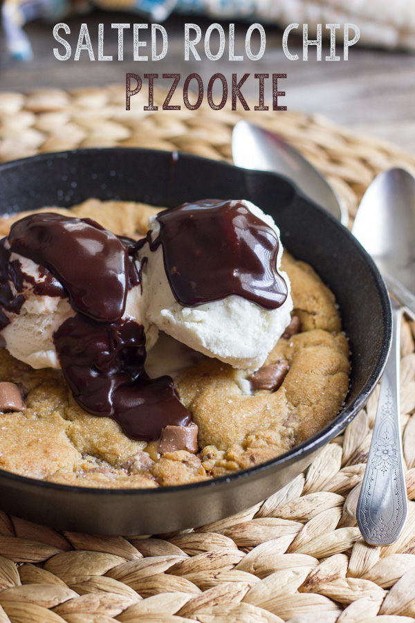 Salted Rolo Chip Pizookie in a small cast iron skillet, topped with vanilla ice cream and Homemade Hot Fudge.  