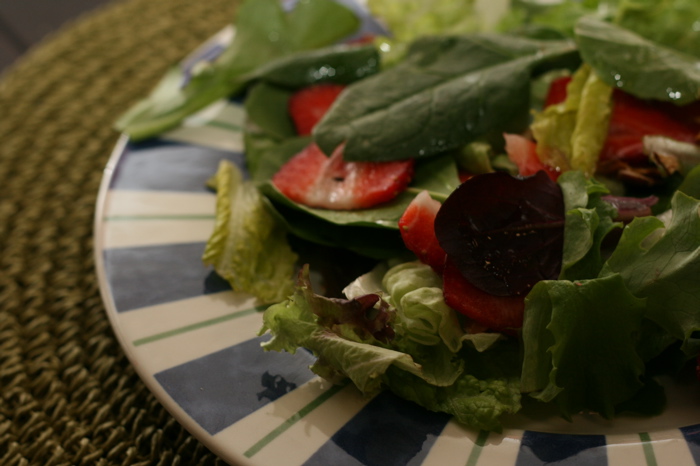 Strawberry and Spinach Salad with Almond Vinaigrette on a plate.  