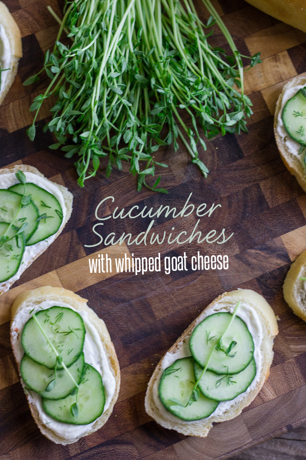 Cucumber Sandwiches With Whipped Goat Cheese on a cutting board with a bundle of pea shoots.  