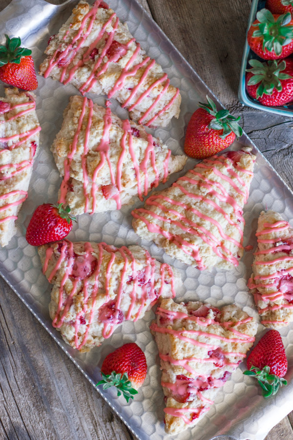 Dreamy Strawberries & Cream Scones on a serving platter with whole strawberries. 