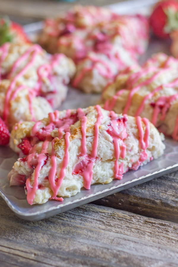 Dreamy Strawberries & Cream Scones on a serving platter with whole strawberries. 