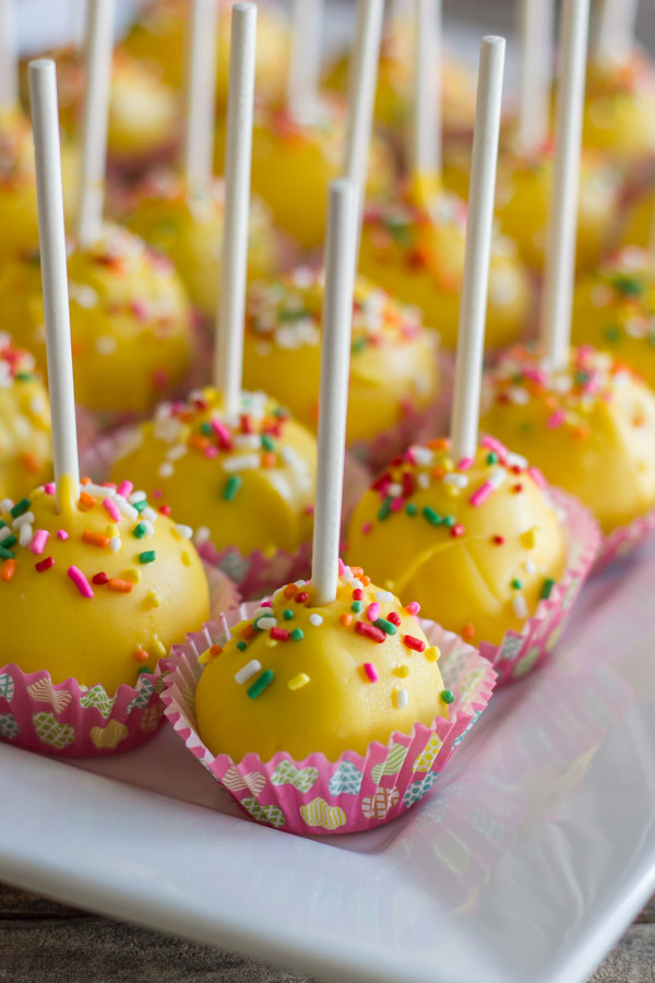 Easy Donut Hole Cake Pops in mini muffin liners arranged on a serving platter.