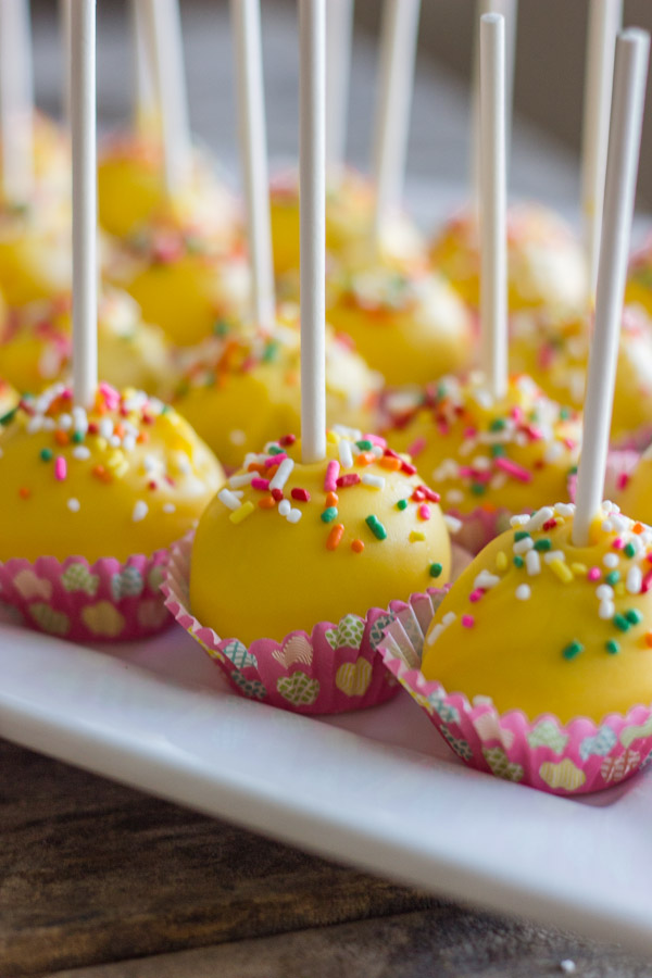Easy Donut Hole Cake Pops in mini muffin liners arranged on a serving platter.