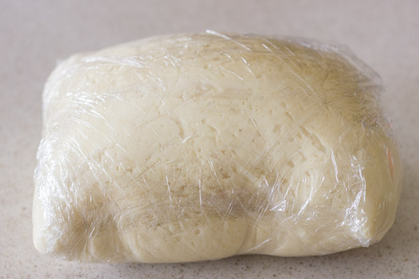 The Best Butterhorn Rolls dough wrapped in plastic wrap.  