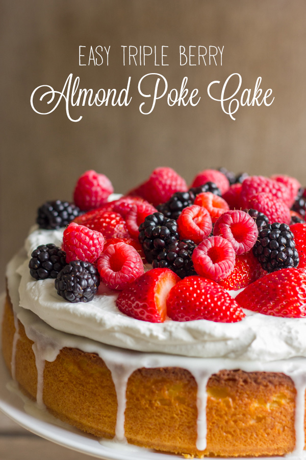 Easy Triple Berry Almond Poke Cake on a cake stand.  
