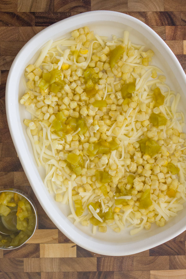 Corn, chiles, and cheese in a well greased baking dish.