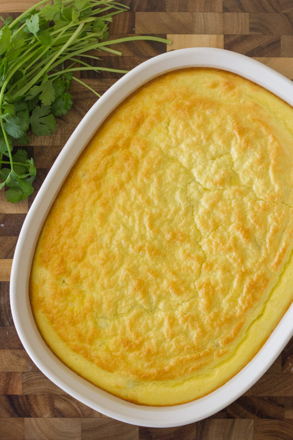 Green Chile Egg Bake Made With Greek Yogurt in a baking dish next to a bundle of cilantro.  