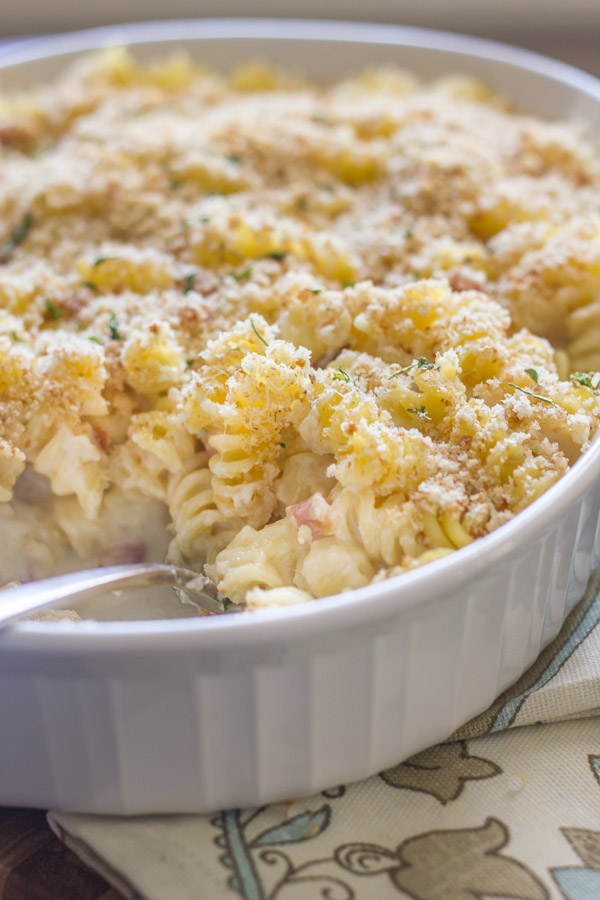 Chicken Cordon Bleu Pasta Bake in a baking dish with a serving spoon in it.  