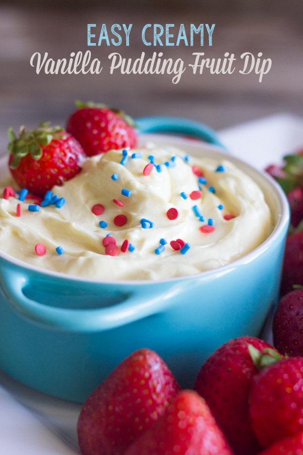 Easy Creamy Vanilla Pudding Fruit Dip in a bowl topped with sprinkles and fresh strawberries, surrounded by more fresh strawberries on a platter.  
