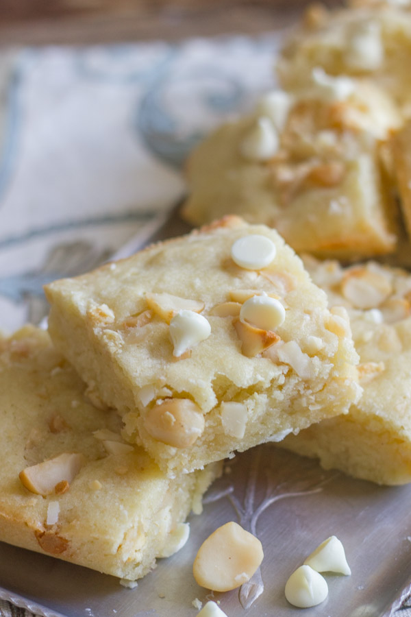 White Chocolate Macadamia Nut Bars arranged on a serving platter.