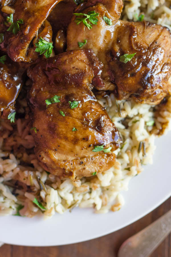 Creamy Balsamic Skillet Chicken served over rice on a plate.  