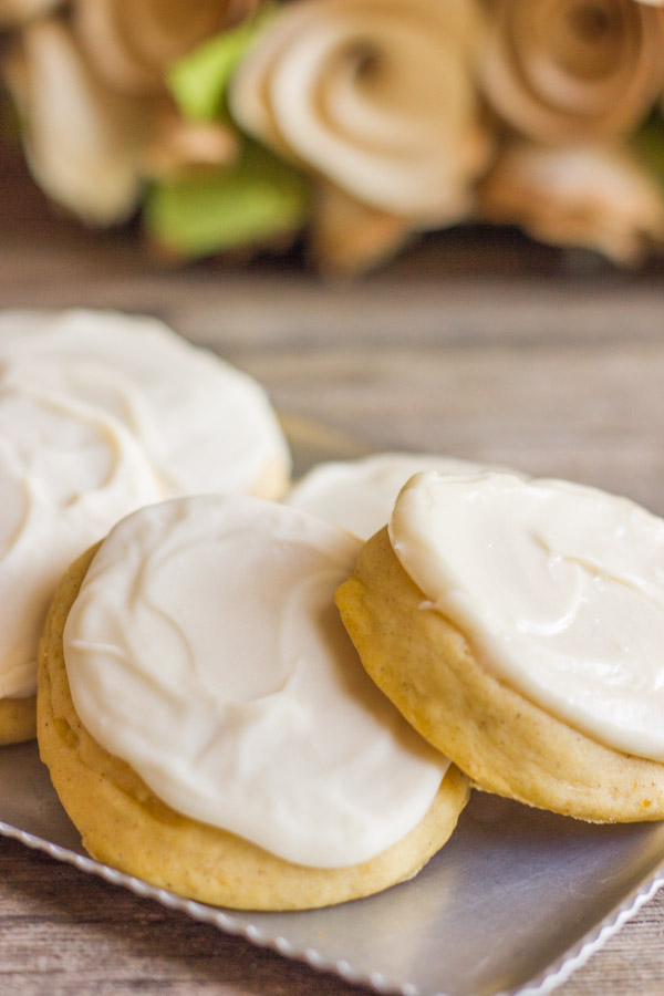 Soft Pumpkin Cookies With Maple Cream Cheese Frosting on a serving platter.  