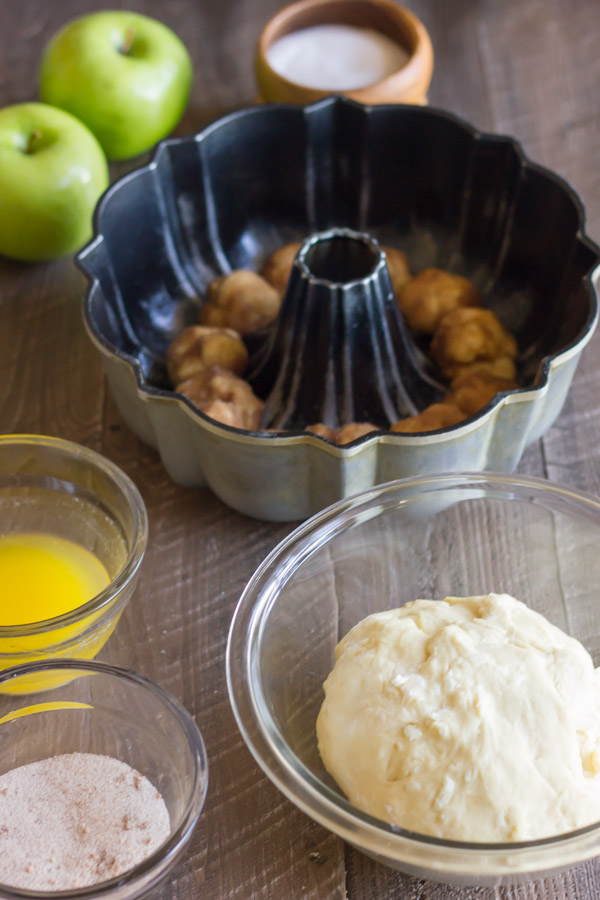 Apple Cinnamon Pull Apart Bread being assembled in a fluted tube pan.