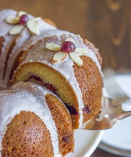 Cranberry Almond Greek Yogurt Cake - Sweet, moist almond cake laced with cranberry sauce and topped with an almond glaze.