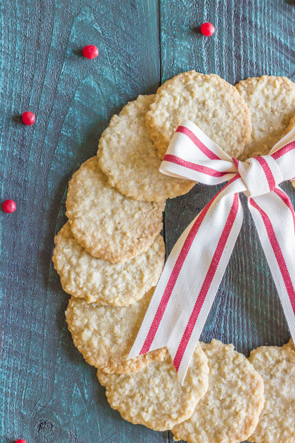Christmas Oatmeal Cookies arranged in a circle to look like a wreath with a white and red striped bow.  