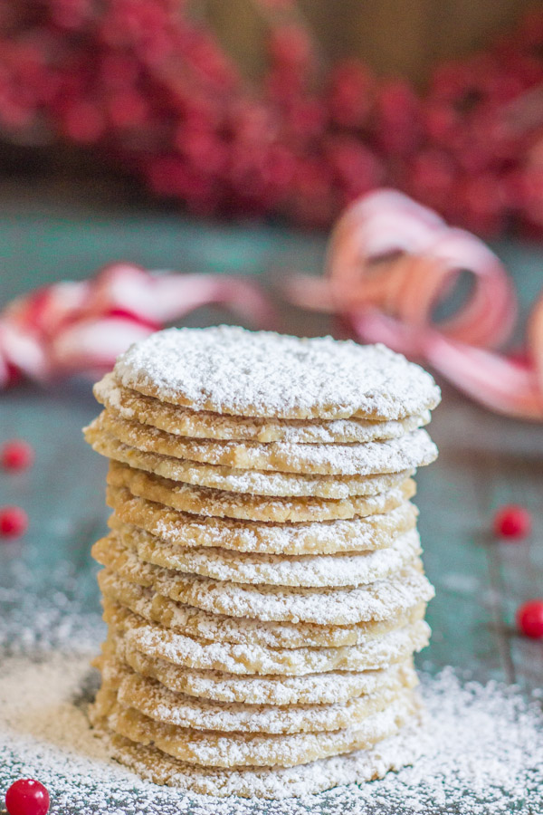 Christmas Oatmeal Cookies stacked in a pile and dusted with powdered sugar.  