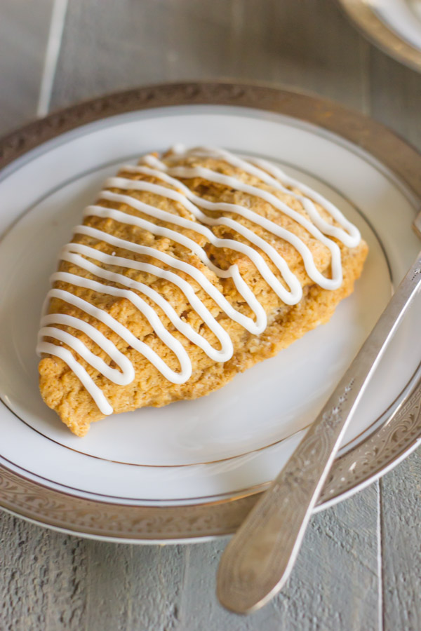 Iced Gingerbread Oat Scone on a plate with a fork.  