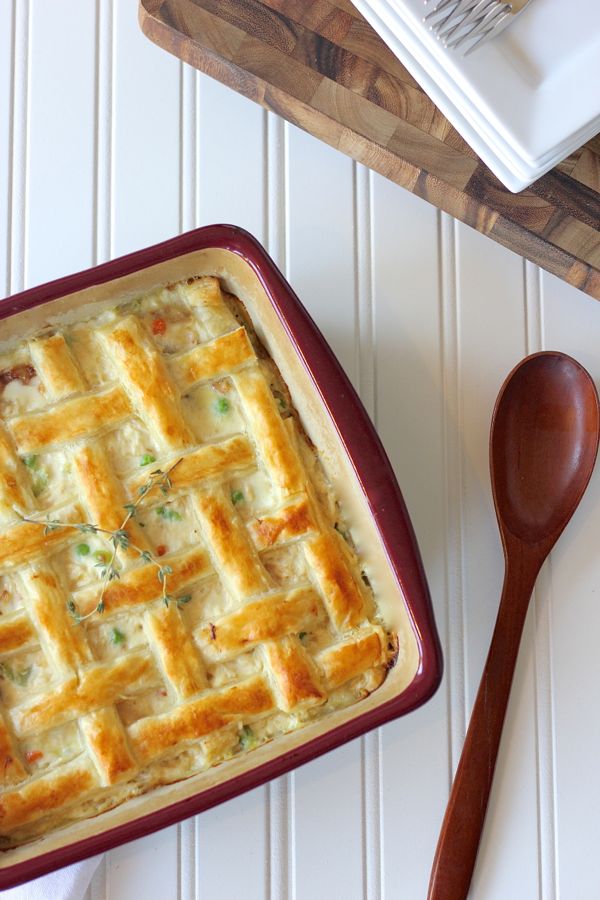 A top down view of a chicken pot pie with a puff pastry lattice crust on top. 