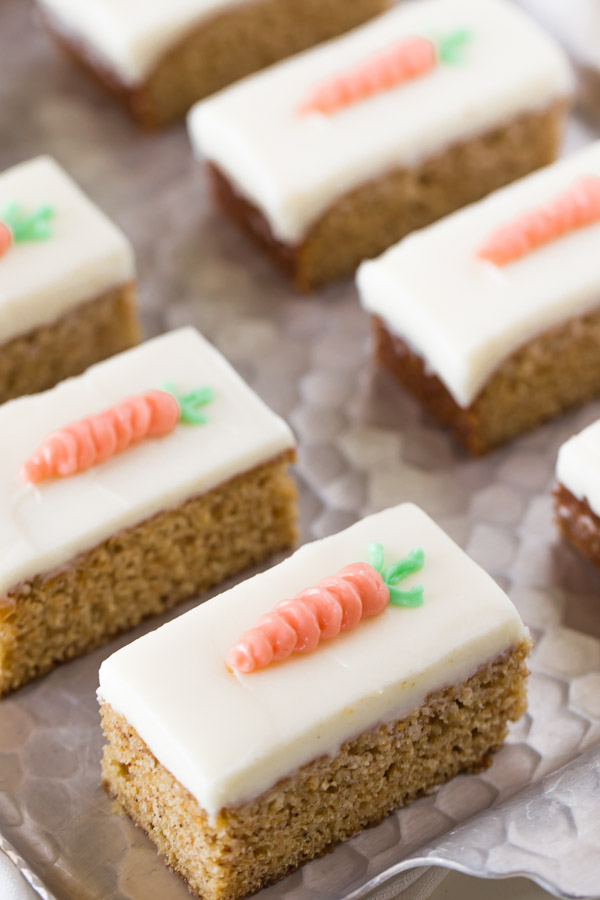 Carrot Cake Bars with Cream Cheese Frosting arranged on a serving tray. 