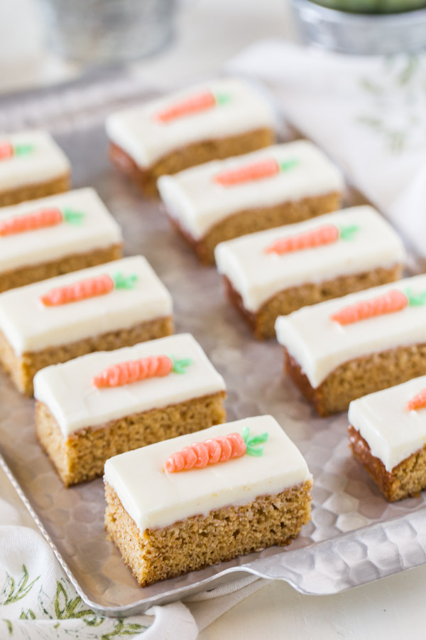 Carrot Cake Bars with Cream Cheese Frosting arranged on a serving tray. 