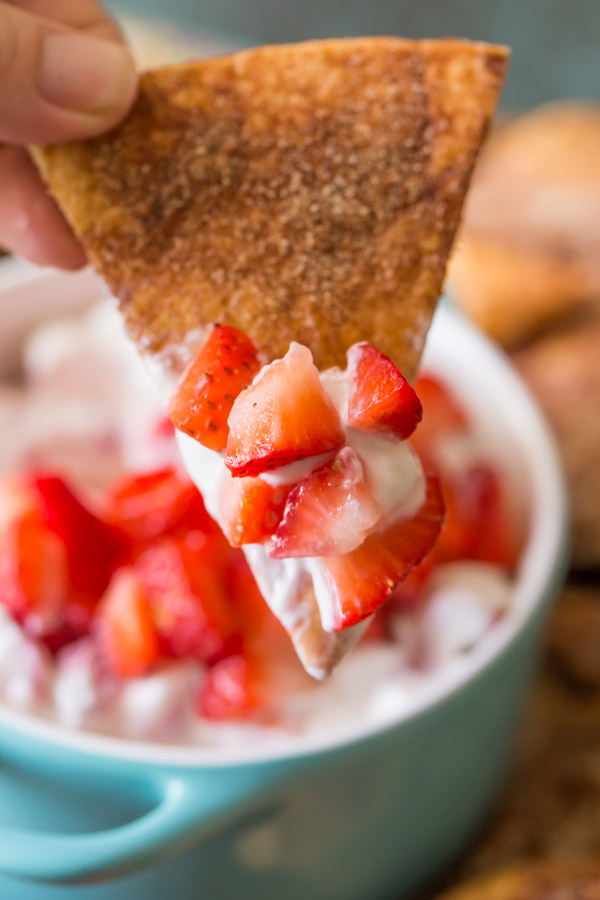 A Baked Cinnamon Crisp that has been dipped into the Creamy Strawberry Dip.  