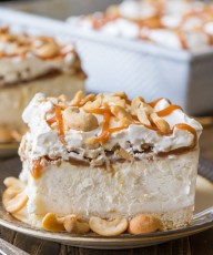 Caramel Cashew Ice Cream Dessert - Creamy vanilla ice cream on a shortbread cookie crust, topped with homemade caramel sauce and cashews of course!