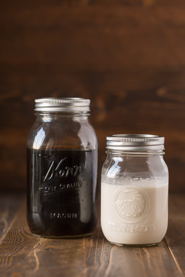 Cold Brew Iced Coffee and Homemade Vanilla Creamer both in mason jars sitting next to each other. 