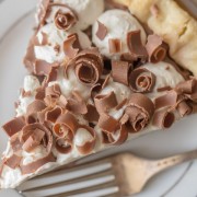 Homemade Chocolate Pudding Pie - Rich, creamy homemade chocolate pudding topped with whipped cream and piled with milk chocolate curls.